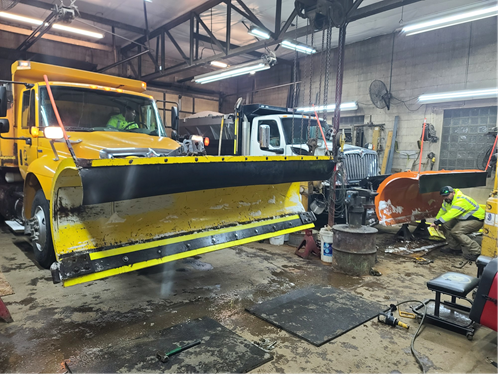 Snowplows being repaired in a City garage.